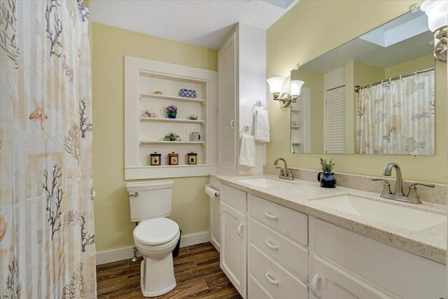 14 Cottage St, Whitman, MA 02382 - bathroom with wood finished floors, double vanity, a skylight, and a shower with curtain