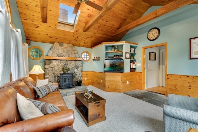 14 Cottage St, Whitman, MA 02382 - carpeted living area featuring wood ceiling, a wainscoted wall, a wood stove, a ceiling fan, and a skylight