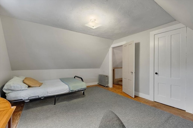 14 Cottage St, Whitman, MA 02382 - bedroom with radiator, vaulted ceiling, and wood finished floors