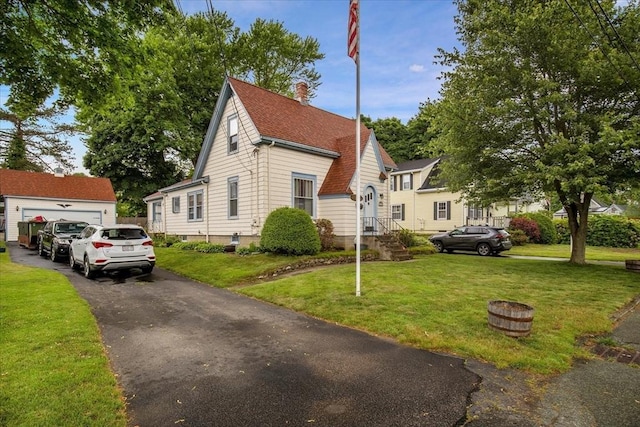 14 Cottage St, Whitman, MA 02382 - view of front facade with a front yard, a detached garage, a chimney, and roof with shingles