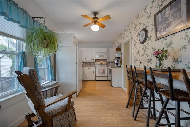 14 Cottage St, Whitman, MA 02382 - kitchen featuring white appliances, wallpapered walls, white cabinets, light wood-style flooring, and light countertops