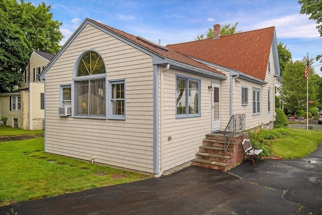 14 Cottage St, Whitman, MA 02382 - view of side of property with roof with shingles, a lawn, a chimney, and cooling unit