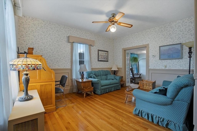 14 Cottage St, Whitman, MA 02382 - living room with ceiling fan, a wainscoted wall, light wood-style floors, and wallpapered walls