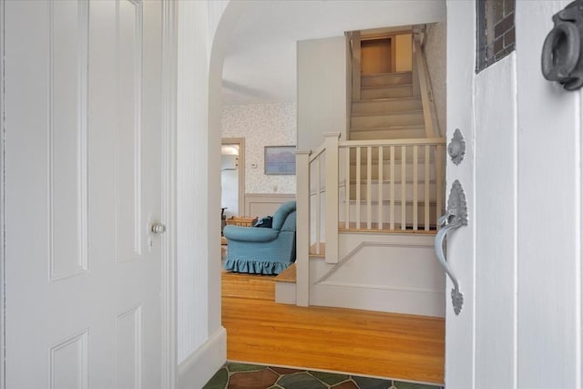 14 Cottage St, Whitman, MA 02382 - foyer entrance featuring wallpapered walls, stairs, a wainscoted wall, arched walkways, and wood finished floors
