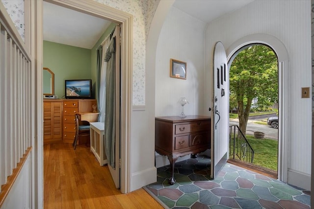 14 Cottage St, Whitman, MA 02382 - foyer entrance with wallpapered walls, light wood-style flooring, and arched walkways
