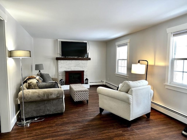 living room featuring a baseboard heating unit, dark hardwood / wood-style flooring, and a healthy amount of sunlight