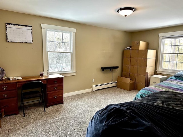 bedroom featuring baseboard heating and light colored carpet