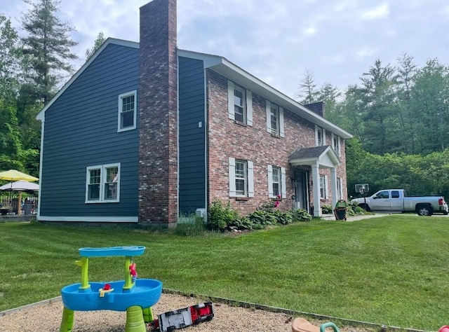 view of side of home featuring a lawn