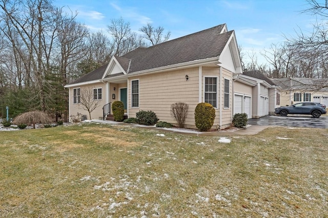 view of front facade with a garage and a front lawn