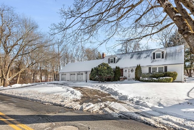 cape cod house featuring a garage