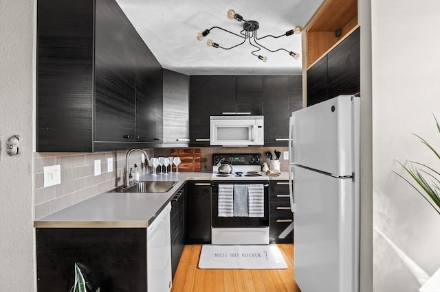 34 Beacon St Unit 3, Chelsea, MA 02150 - kitchen with white appliances, dark cabinetry, tasteful backsplash, and light countertops