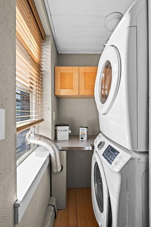 34 Beacon St Unit 3, Chelsea, MA 02150 - washroom featuring stacked washer / dryer and wood finished floors