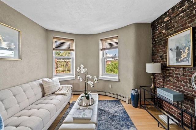 34 Beacon St Unit 3, Chelsea, MA 02150 - living area with plenty of natural light, wood finished floors, baseboard heating, and a textured wall