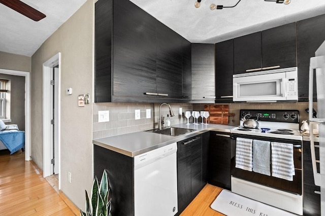 34 Beacon St Unit 3, Chelsea, MA 02150 - kitchen with white appliances, dark cabinetry, tasteful backsplash, and light countertops