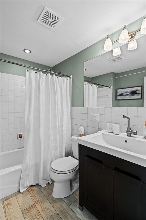 34 Beacon St Unit 3, Chelsea, MA 02150 - full bath featuring tile walls, vanity, shower / bath combination with curtain, wood finished floors, and recessed lighting