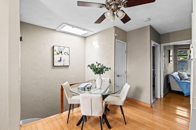 34 Beacon St Unit 3, Chelsea, MA 02150 - dining room featuring a ceiling fan, wood finished floors, a textured wall, and a skylight