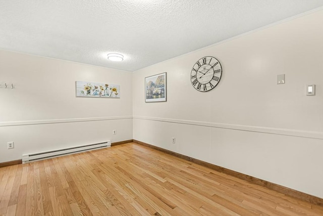 191 Franklin St Unit A, Stoneham, MA 02180 - unfurnished room featuring baseboard heating, a textured ceiling, wood finished floors, and baseboards