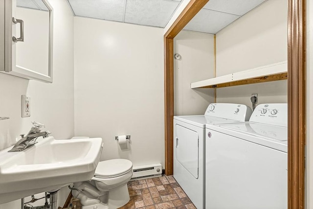 191 Franklin St Unit A, Stoneham, MA 02180 - laundry room featuring a baseboard radiator, washer and dryer, and stone finish flooring