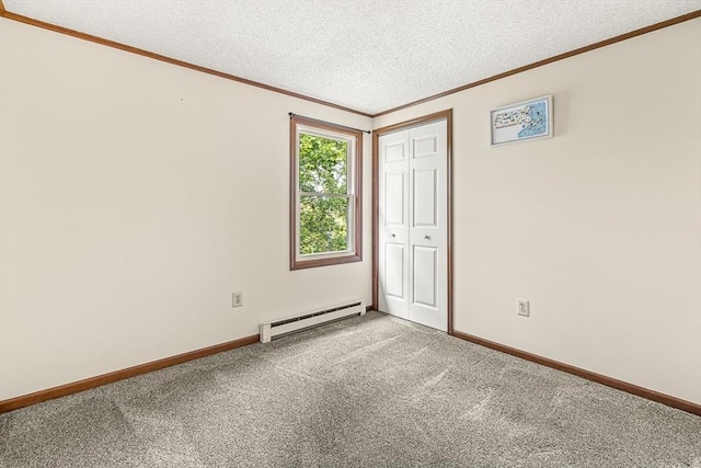 191 Franklin St Unit A, Stoneham, MA 02180 - carpeted spare room featuring a baseboard radiator, crown molding, a textured ceiling, and baseboards