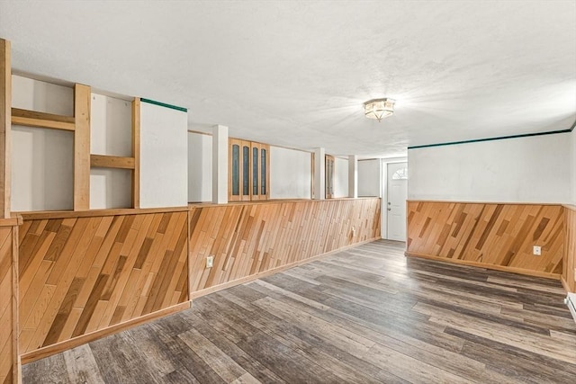 191 Franklin St Unit A, Stoneham, MA 02180 - empty room with wood walls, wood finished floors, and a wainscoted wall