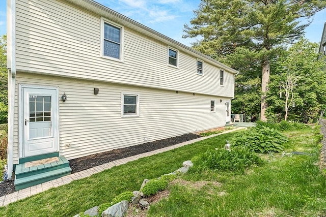 191 Franklin St Unit A, Stoneham, MA 02180 - view of home's exterior featuring a lawn