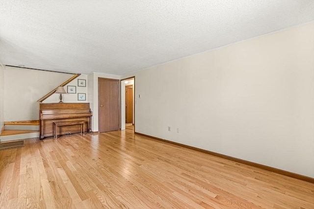 191 Franklin St Unit A, Stoneham, MA 02180 - unfurnished room with a textured ceiling, light wood finished floors, and baseboards