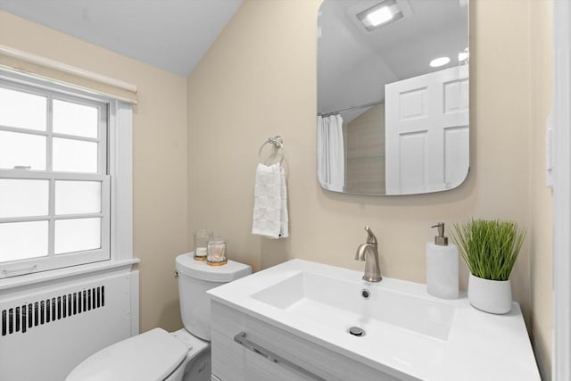 full bathroom with radiator, lofted ceiling, a wealth of natural light, and toilet