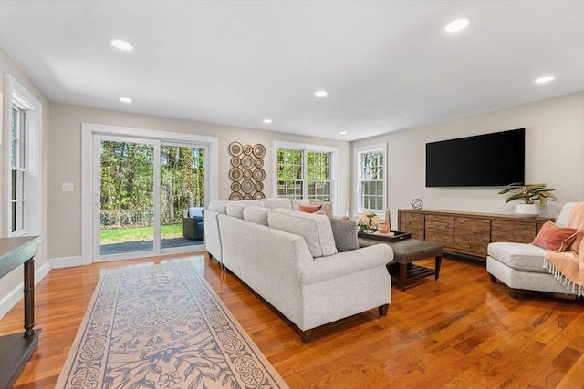 living area featuring recessed lighting, light wood-style flooring, and a wealth of natural light
