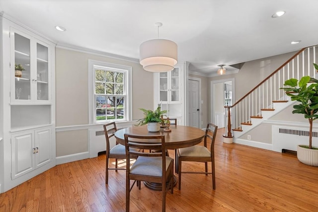 dining room with ornamental molding, radiator, stairs, recessed lighting, and light wood-style flooring