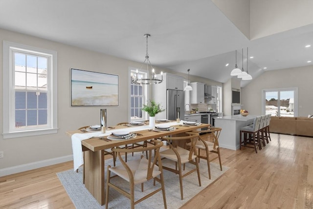 47 Spring St, Rehoboth, MA 02769 - dining area featuring light wood-type flooring, a chandelier, vaulted ceiling, baseboards, and recessed lighting