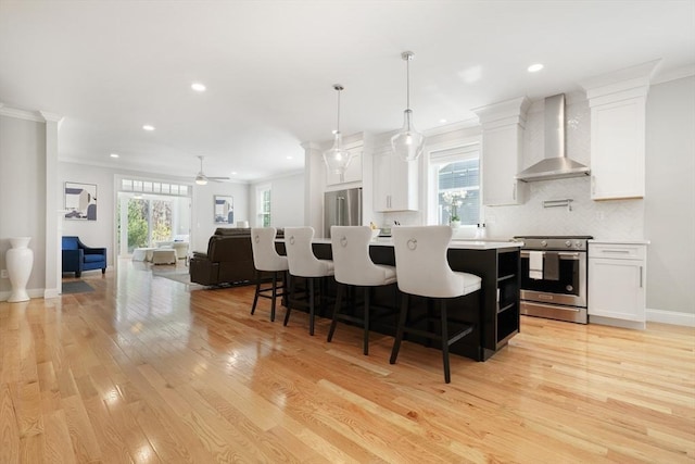 47 Spring St, Rehoboth, MA 02769 - kitchen with wall chimney exhaust hood, appliances with stainless steel finishes, open floor plan, light wood finished floors, and recessed lighting
