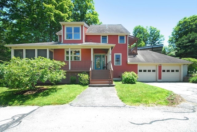 4 Half Moon Hl Unit 4, Acton, MA 01720 - view of front facade featuring covered porch, a front yard, concrete driveway, and a garage