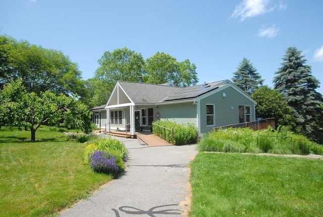 4 Half Moon Hl Unit 4, Acton, MA 01720 - view of front of property featuring a front yard, covered porch, and roof mounted solar panels