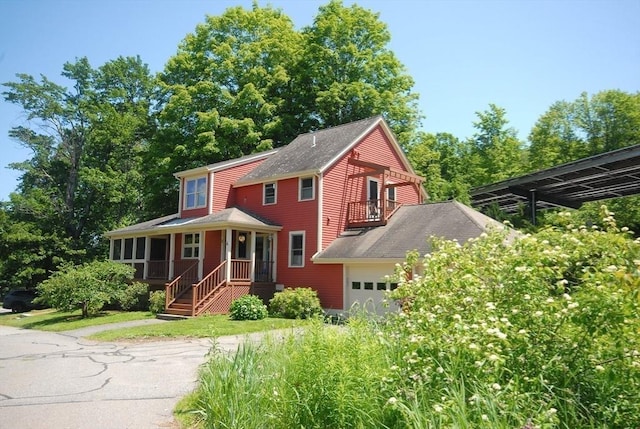 4 Half Moon Hl Unit 4, Acton, MA 01720 - view of front of home with a balcony, a sunroom, roof with shingles, and a garage