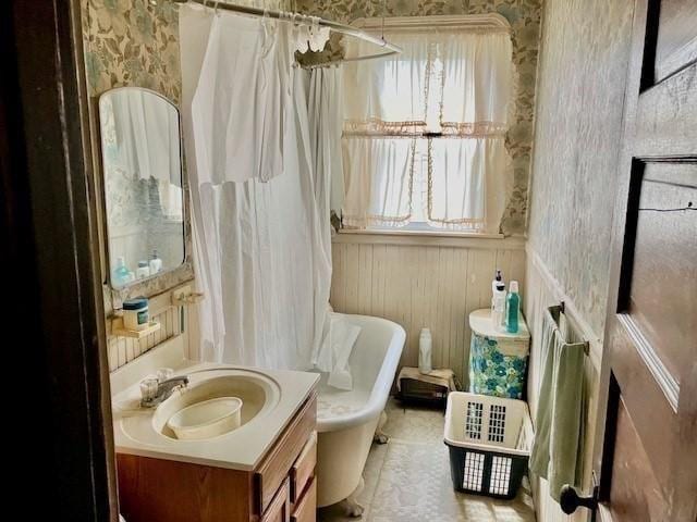 full bathroom featuring toilet, vanity, and plus walk in shower