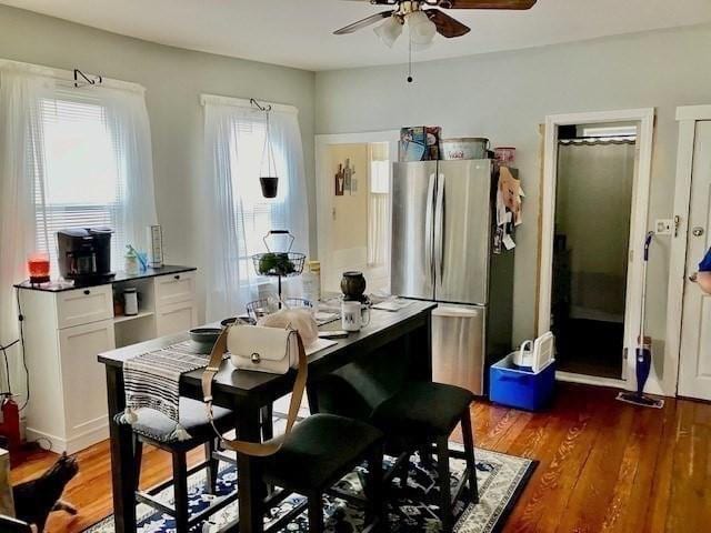 dining area featuring dark wood-type flooring and ceiling fan