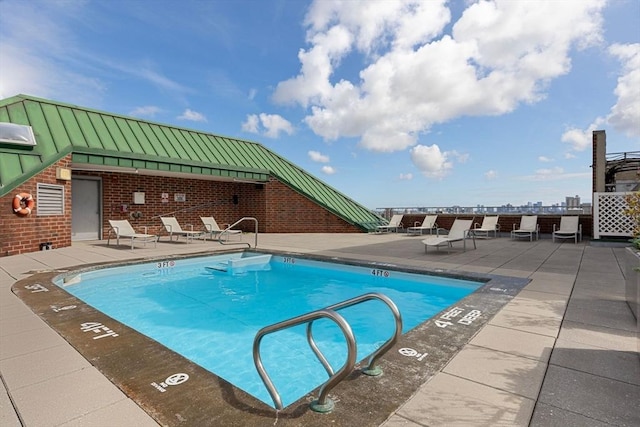 view of swimming pool with a patio