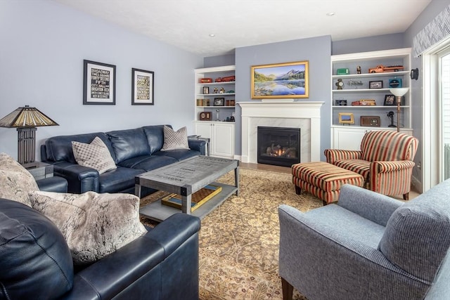 living room with built in features and a premium fireplace