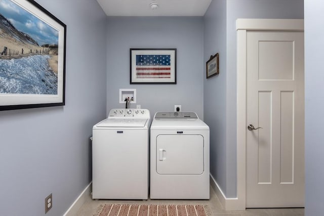 laundry room featuring washer and dryer and light tile patterned floors