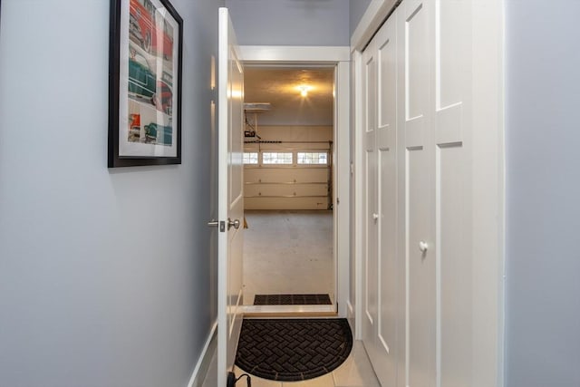 hall with tile patterned floors