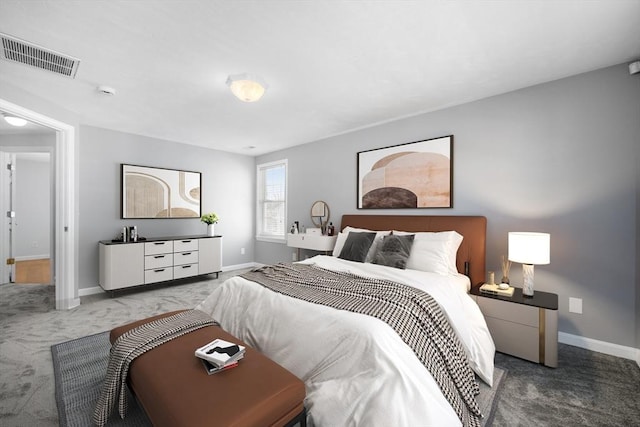 carpeted bedroom featuring visible vents and baseboards