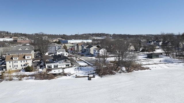 snowy aerial view with a residential view