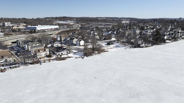 snowy aerial view with a residential view