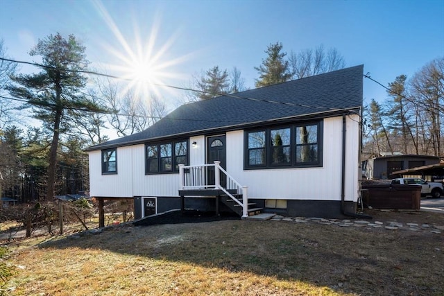 view of front of property featuring a shingled roof