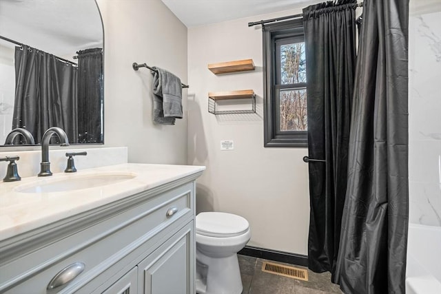 bathroom with toilet, vanity, baseboards, and shower / tub combo