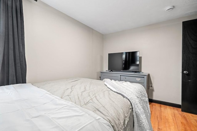 bedroom featuring light wood-style flooring and baseboards