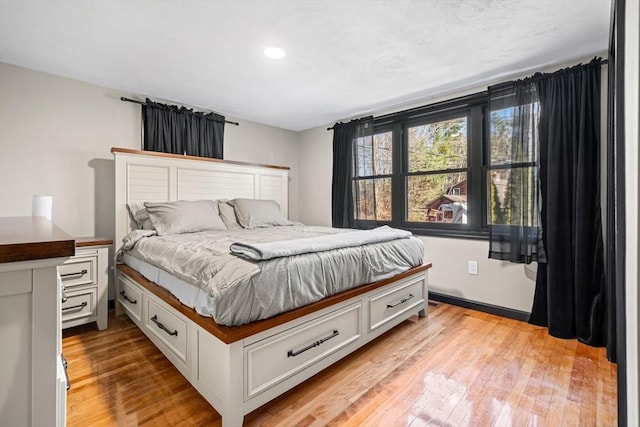 bedroom featuring light wood finished floors and recessed lighting
