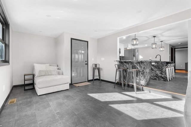 living area featuring baseboards