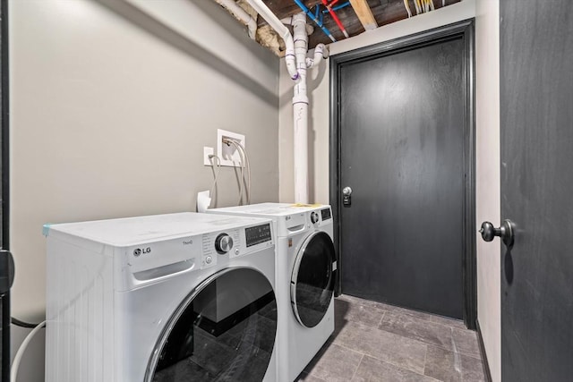 laundry room with washing machine and clothes dryer