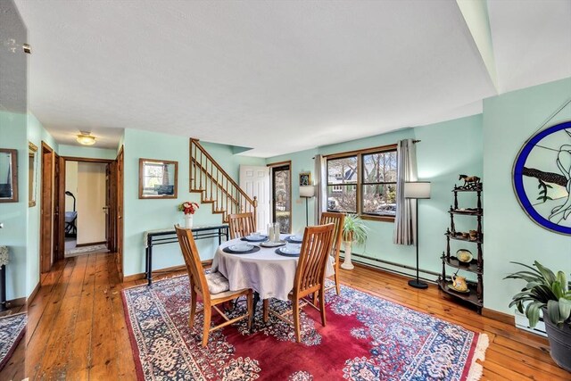 67 Whippoorwill Cir, Mashpee, MA 02649 - dining space with stairway, hardwood / wood-style floors, baseboards, and baseboard heating
